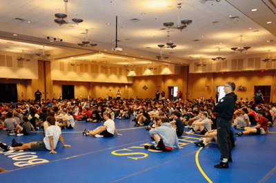 Wrestlers sitting down for a discussion on wrestling techniques.