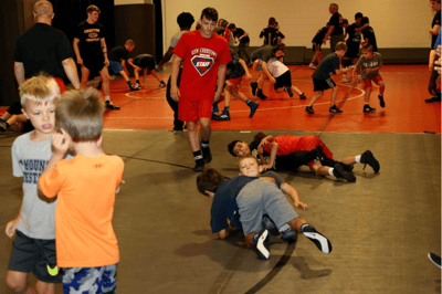 Youth wrestlers sparring at camp.