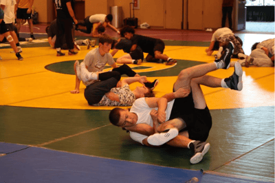Teen wrestlers sparring at camp.