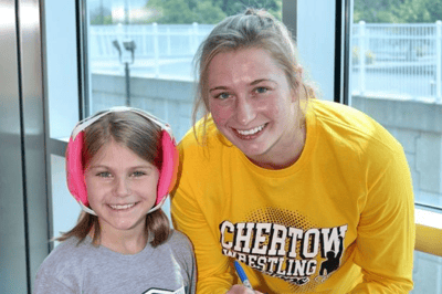 Kylie Welker with a youth female wrestler.