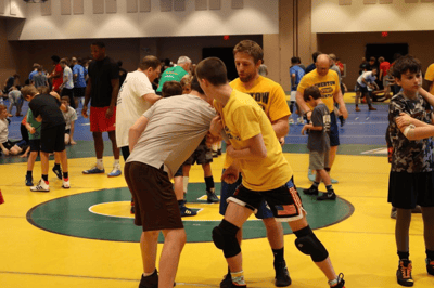 Two teen boy wrestlers sparring.