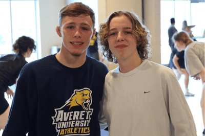 Two male teen wrestling campers.