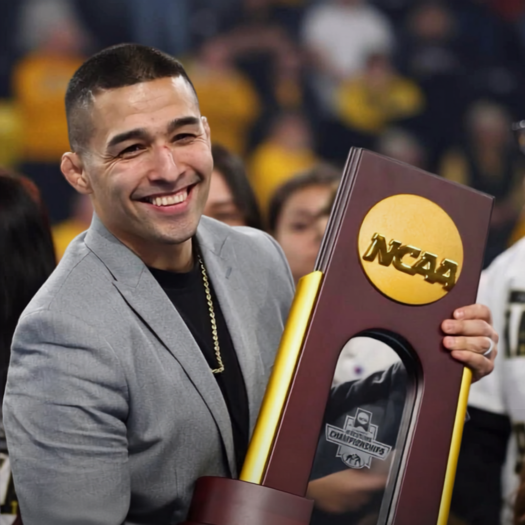 Alexio Garcia holding NCAA championship trophy