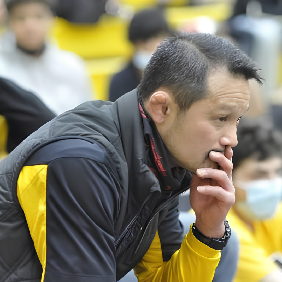 Sanshiro Abe coaching a wrestling match