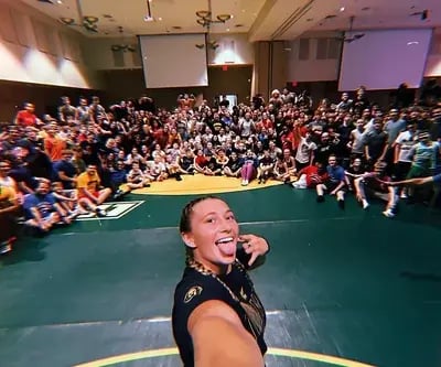 Coach Kylie Welker posing with campers at Ken Chertow's Summer Wrestling Camps.