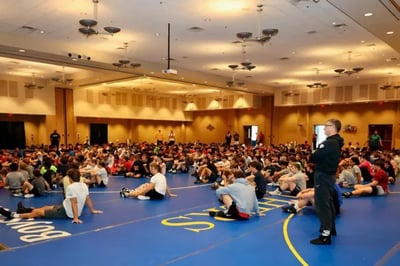 Wrestlers sitting down for a discussion on wrestling techniques.