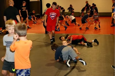 Youth wrestlers sparring at camp.