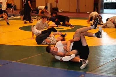 Teen wrestlers sparring at camp.