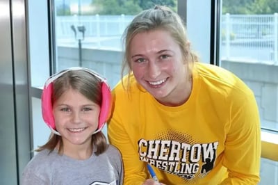 Kylie Welker with a youth female wrestler.