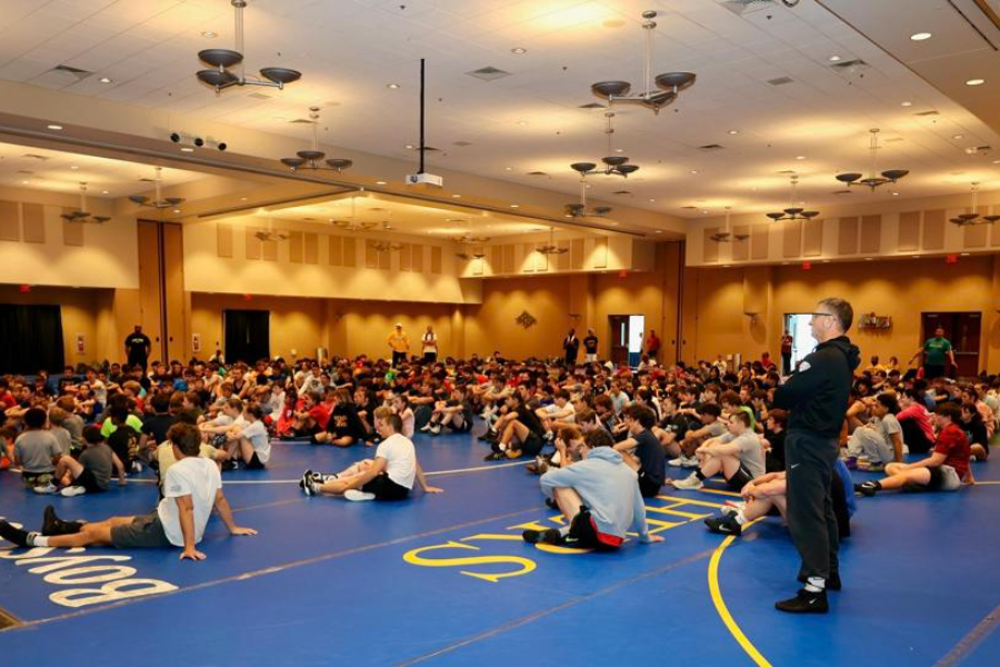 Wrestlers sitting down for a discussion on wrestling techniques. 