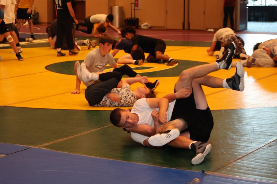 Teen wrestlers sparring at camp. 