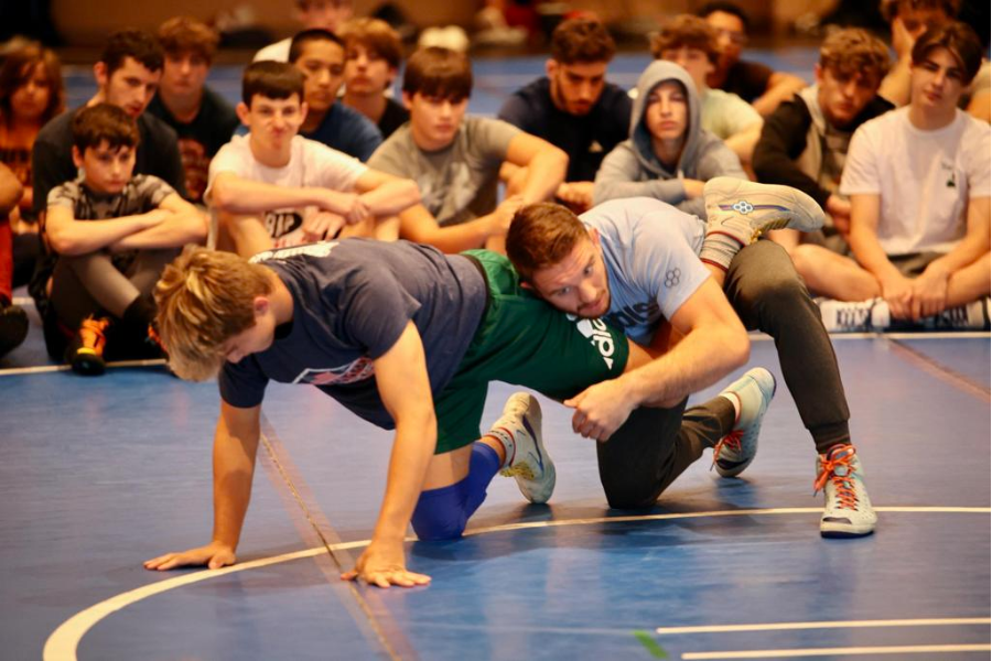 Zain Retherford wrestling with a teen camper.