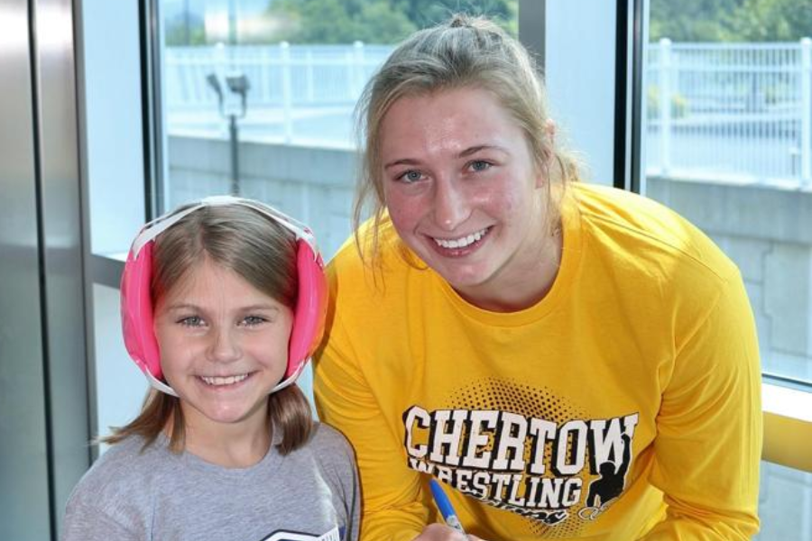 Kylie Welker with a youth female wrestler. 