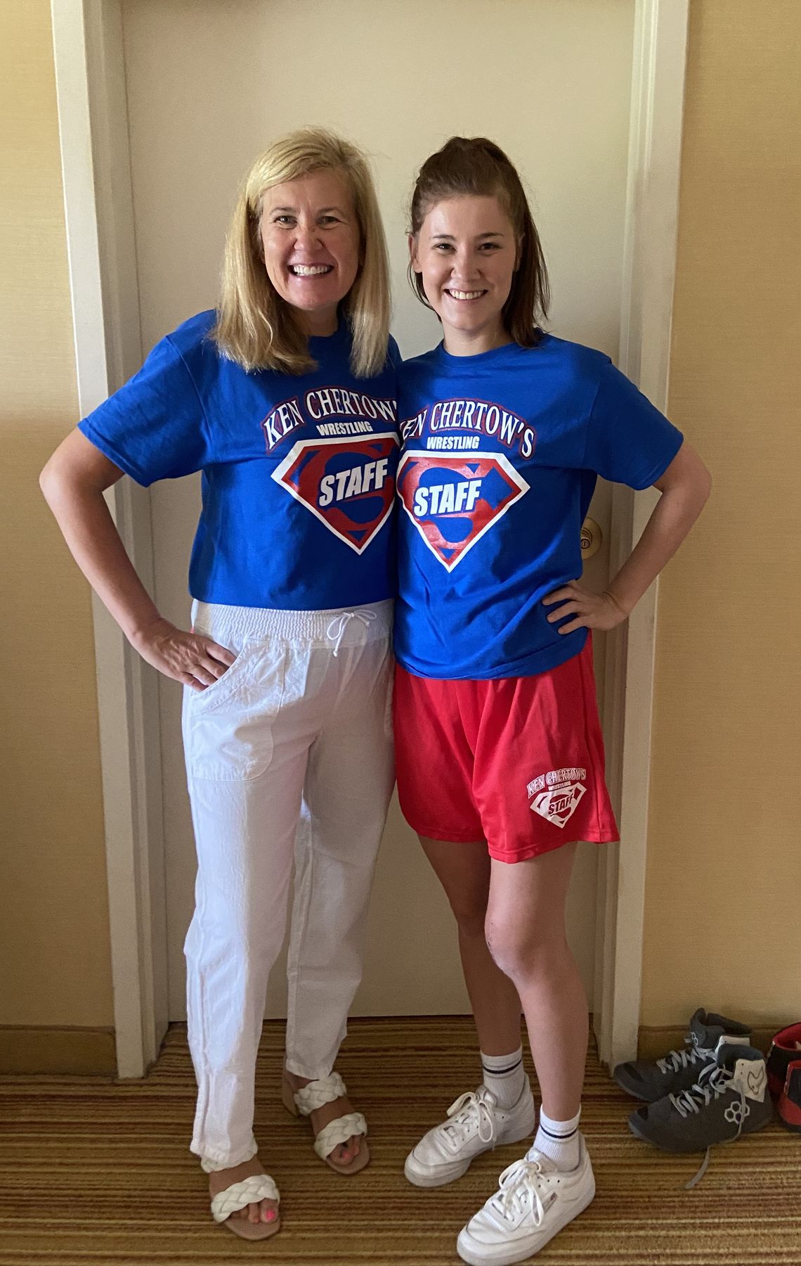 Beth Chertow and her daughter in blue Ken Chertow's Staff shirts at summer wrestling camp