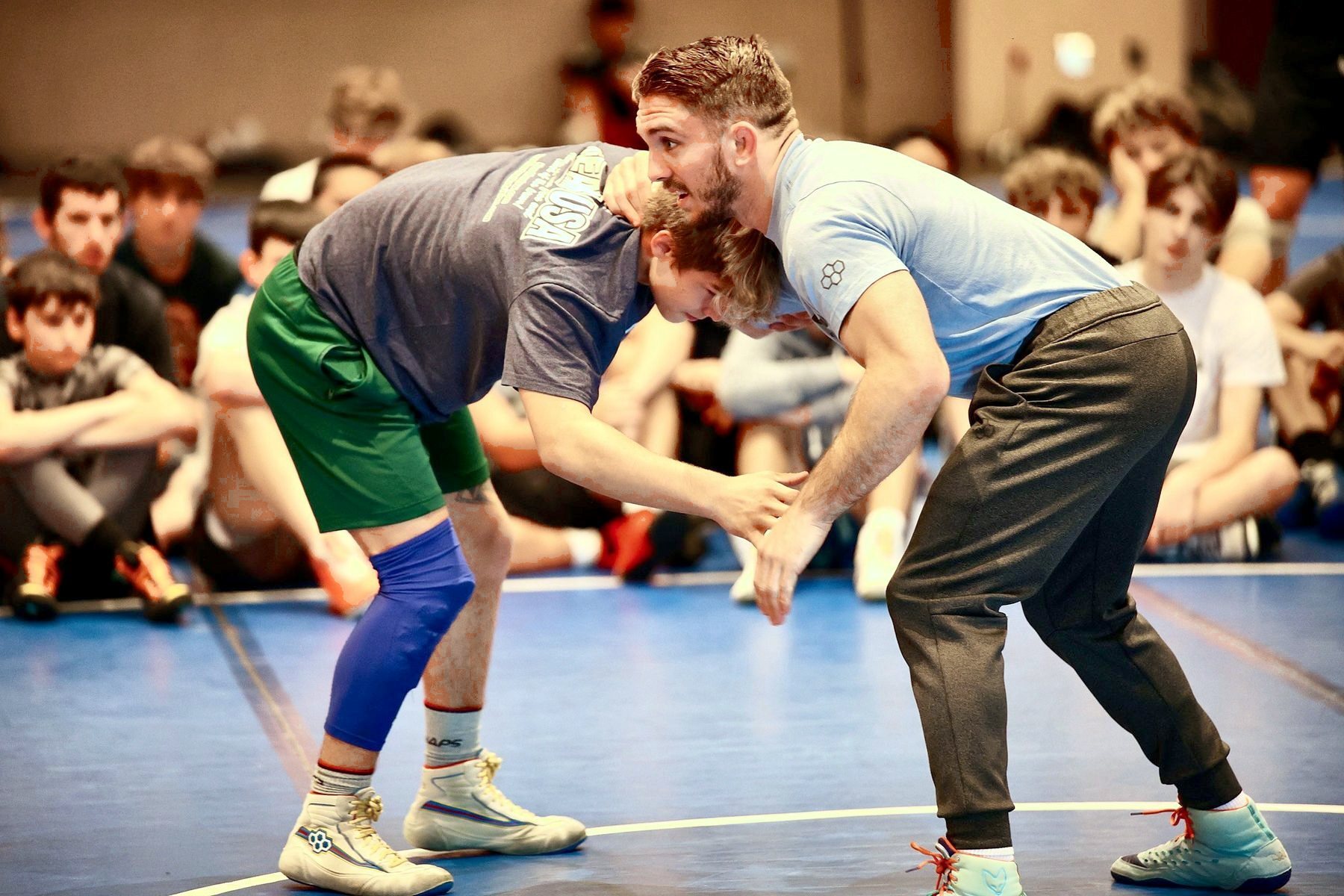 A coach and a camper in a stance during a technique demo at Ken Chertow Gold Medal Training Camp