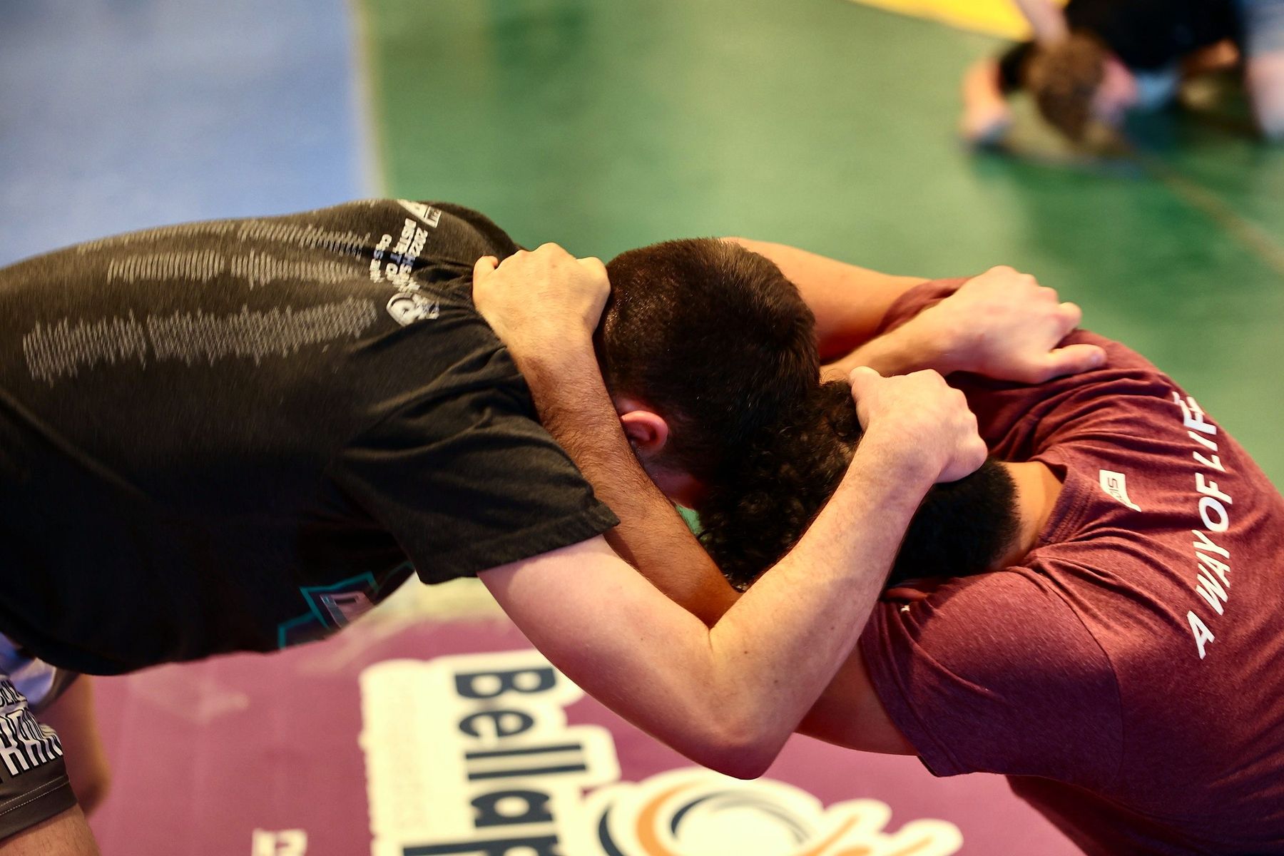 Two wrestlers locked up in a hand-fighting drill at Ken Chertow's summer wrestling camp
