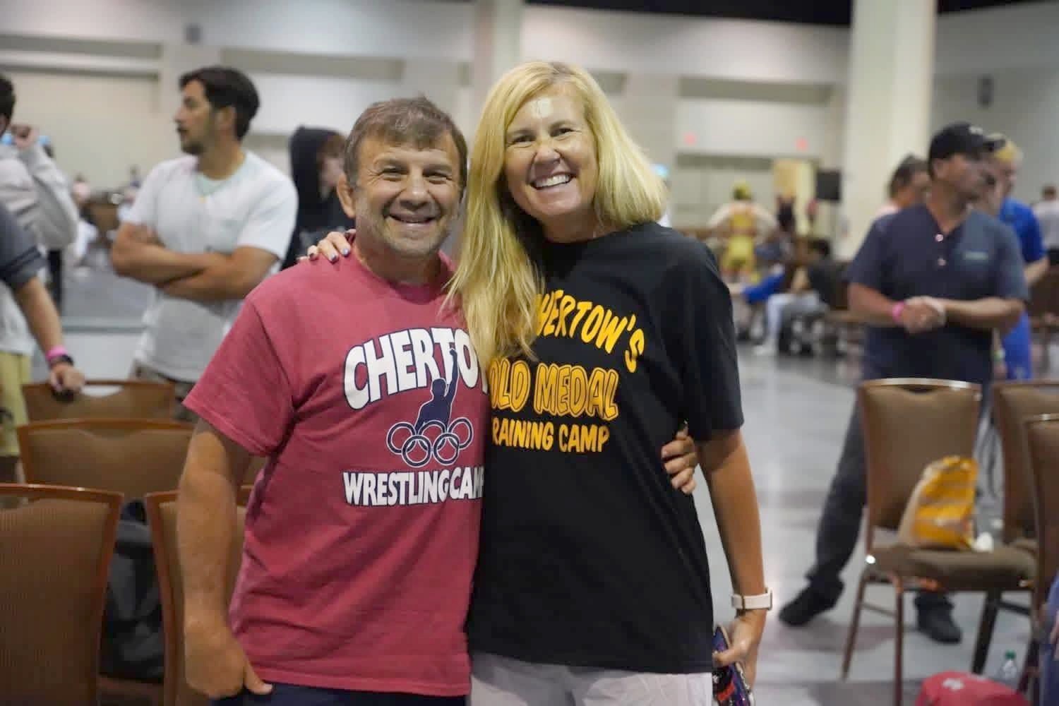 Ken and Beth Chertow in camp shirts at Ken Chertow's summer wrestling camp