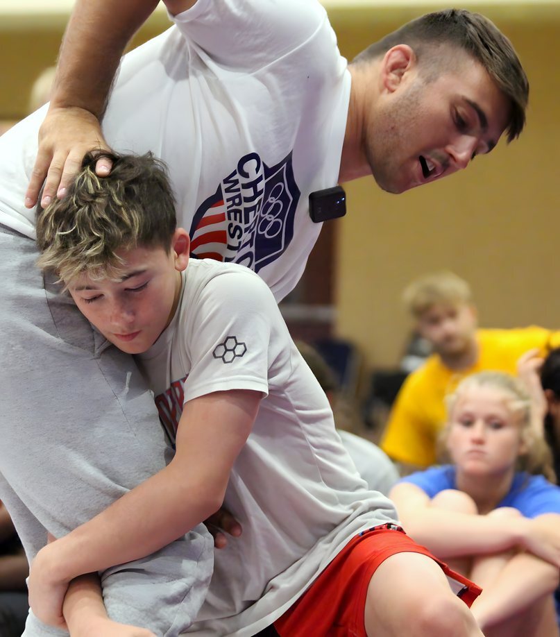 Pat Glory demonstrating a single-leg on a young wrestler at Ken Chertow's summer wrestling camp
