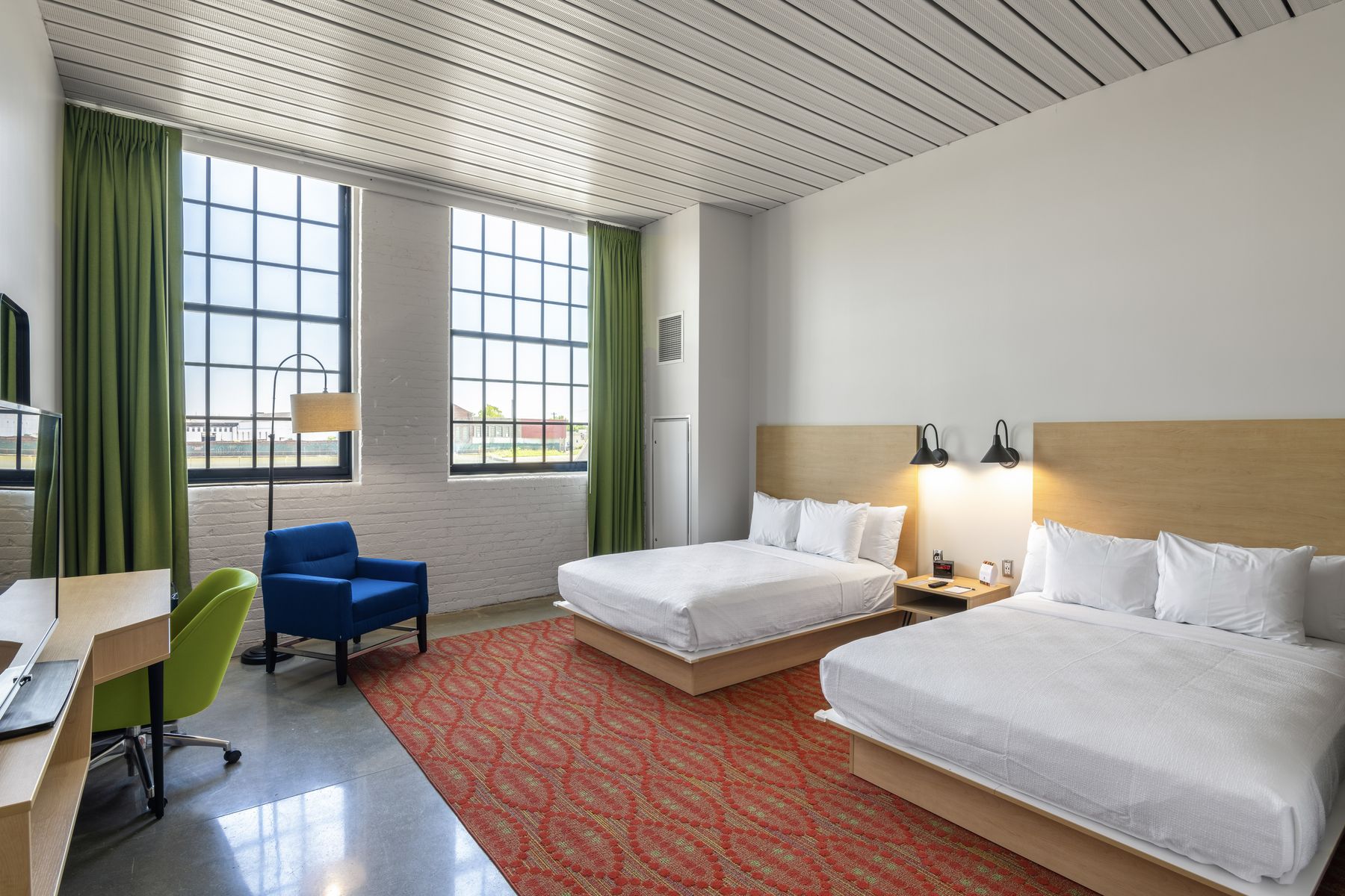 A two-queen-bed room with tall windows at the Warehouse Hotel at Champion Mill, for Ken Chertow's Ohio camp