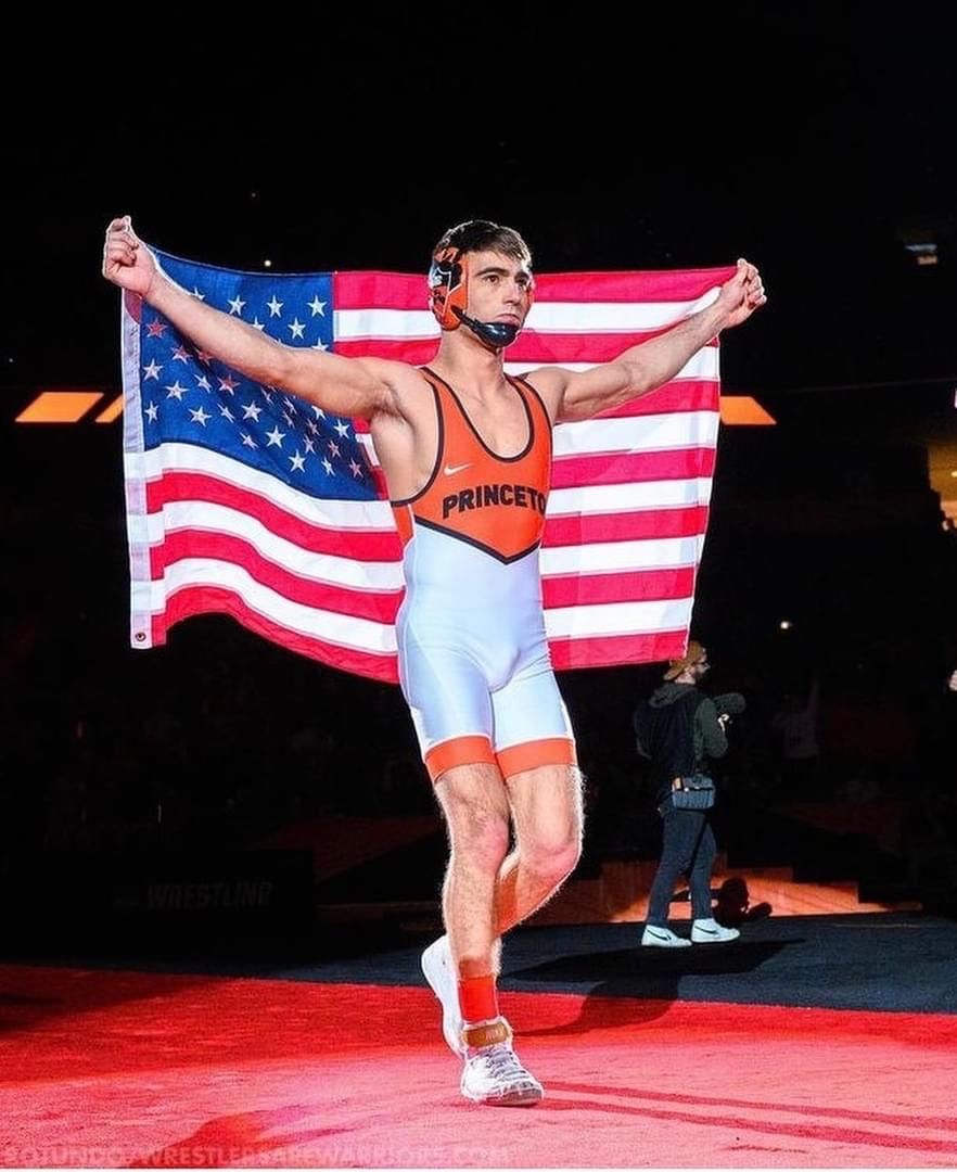 Pat Glory, Ken Chertow wrestling camp coach, walking out with an American flag in a Princeton singlet