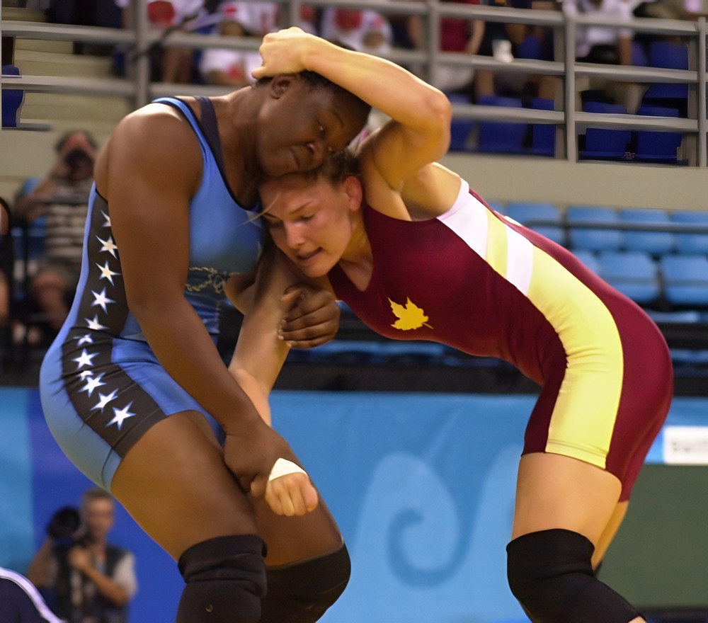 Toccara Montgomery in a Team USA singlet, tied up with a Canadian wrestler