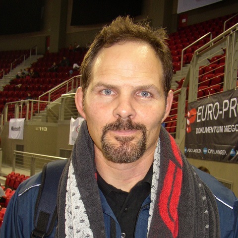Bill Scherr with a goatee, wearing a scarf and jacket, coach at Ken Chertow's summer wrestling camp
