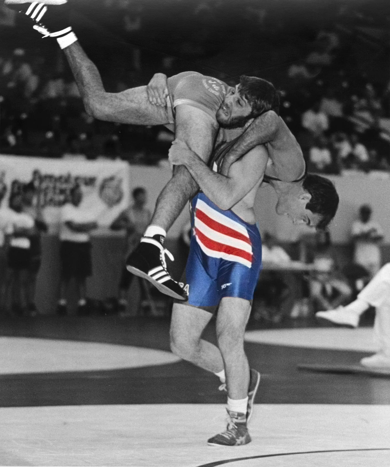 Ken Chertow lifting an opponent in his USA singlet, founder of Ken Chertow's summer wrestling camp