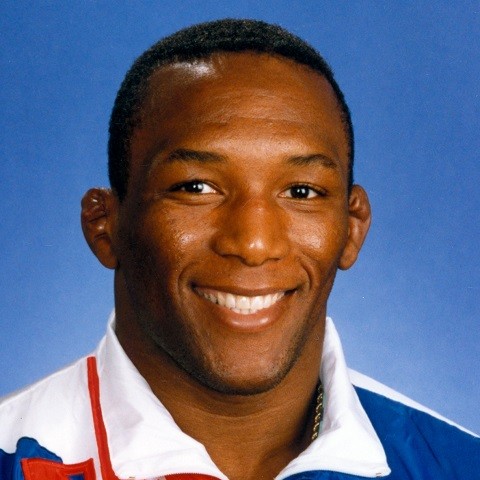 Nate Carr smiling, in a USA team jacket, a Ken Chertow summer wrestling camp clinician