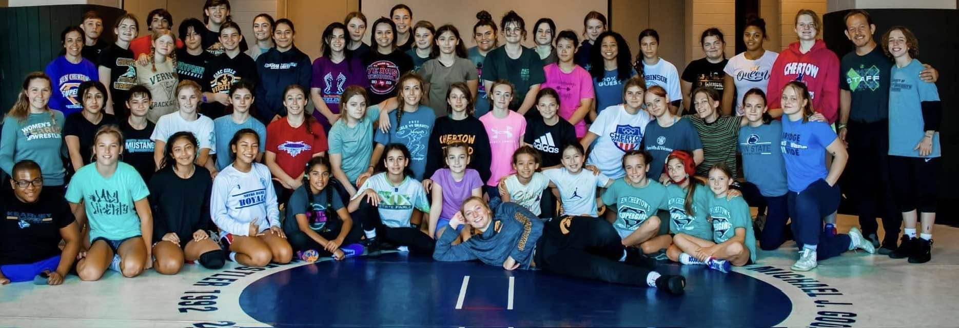 A big group of girls and coaches together at Ken Chertow's SuperGirl girls wrestling summer camp