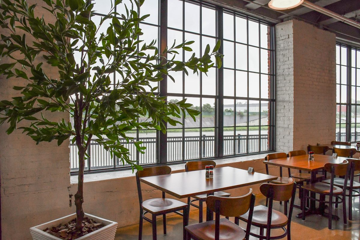 Restaurant tables beside tall windows at Spooky Nook, where SuperGirl girls wrestling summer camp families eat